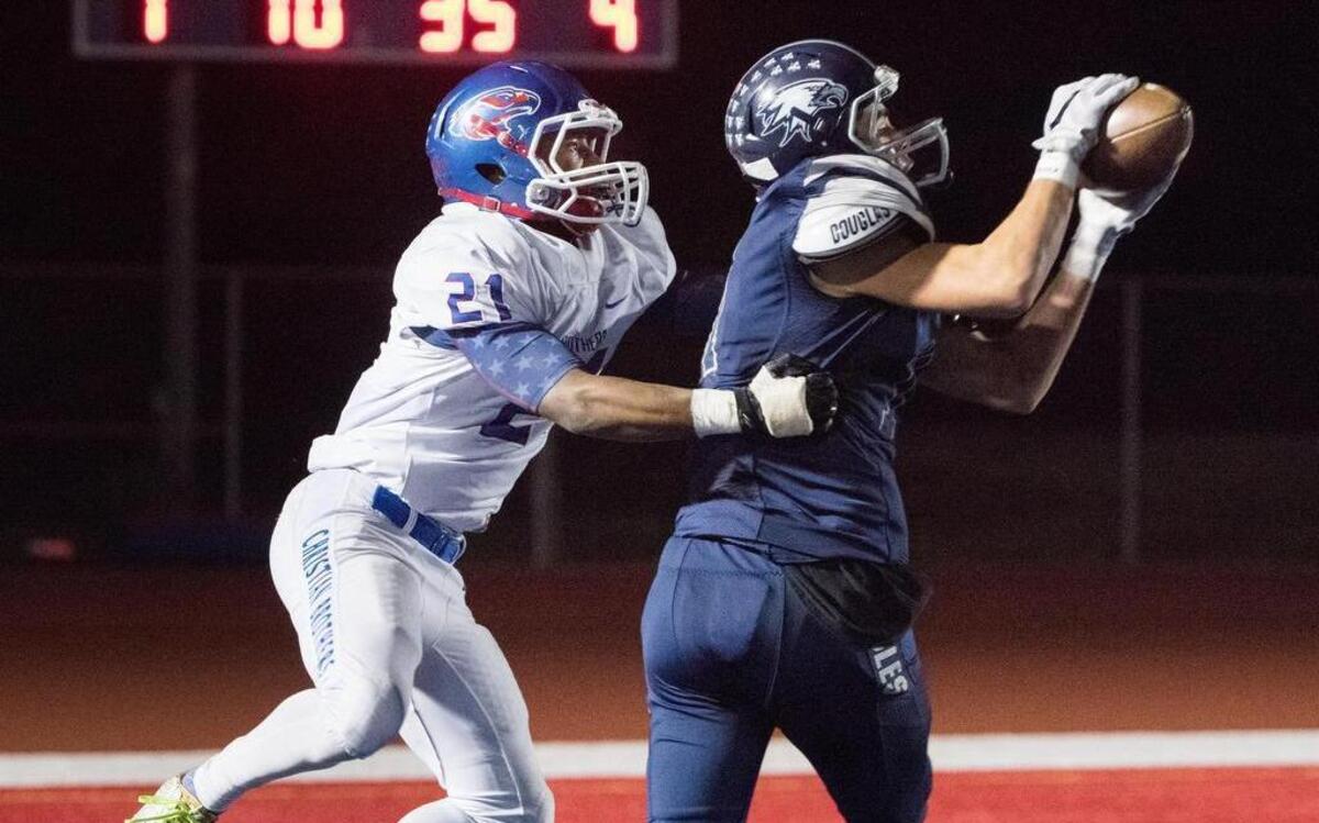 Vista del Lago Eagles' Landon Mitchell (11) intercepts a pass intended for Christian Brothers Falcons' Jamarri Jackson (21) near the Christian Brothers' end zone in the fourth quarter, as the Eagles host the Falcons at Folsom High School on Friday, November 6, 2015.