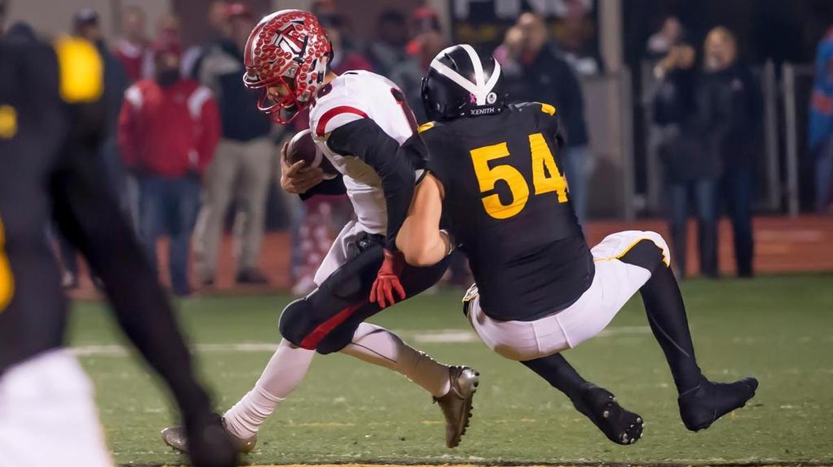 Antelope High School quarterback Nick Spagnola is sacked by Del Oro’s Hunter Halverson (54) in Friday night’s 50-10 Golden Eagles victory.