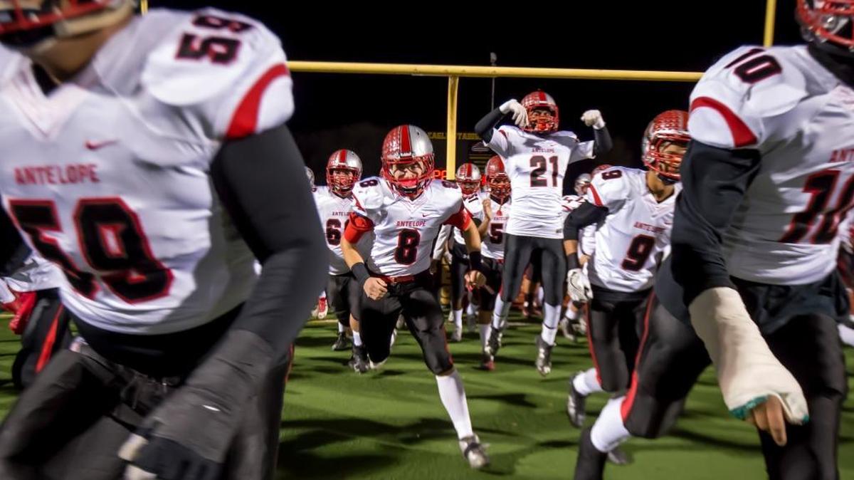 The Antelope High School Titans come on the to the field before a playoff game last season. The Titans beat Elk Grove in a Sac-Joaquin Section Division II opener on Thursday.