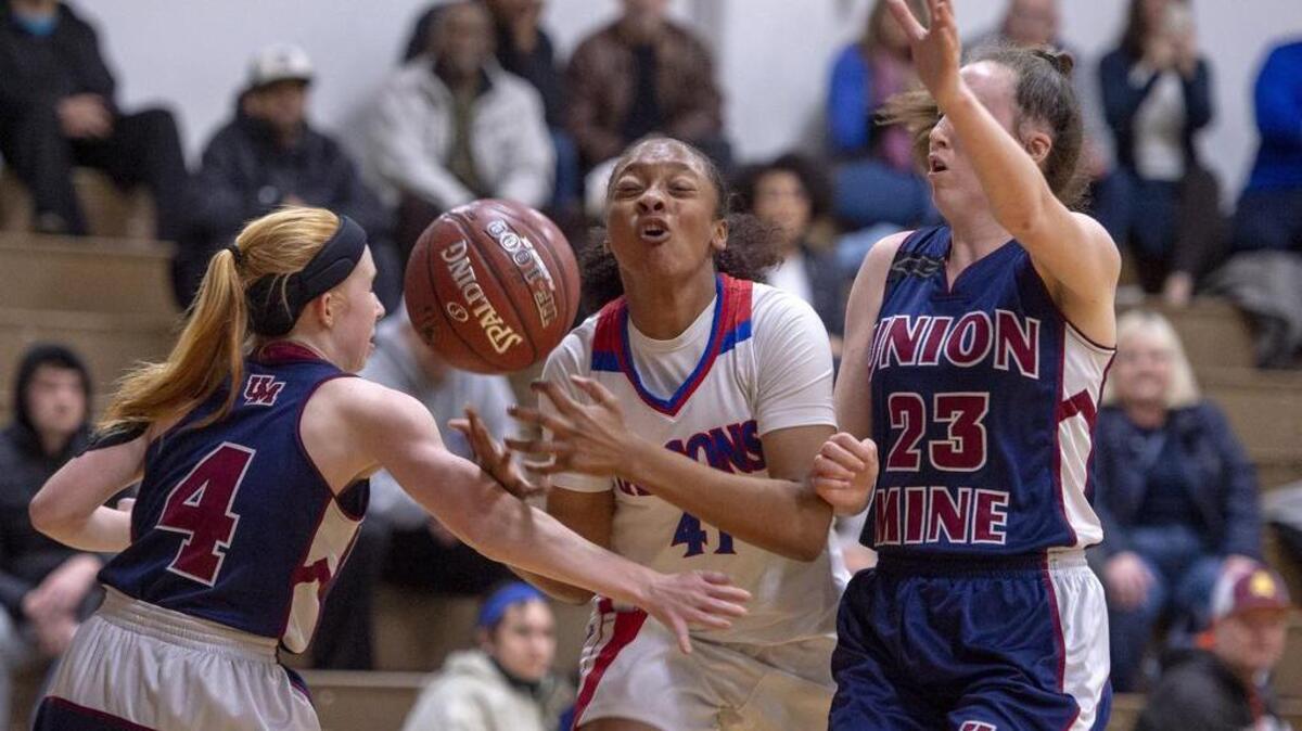 Falcons guard Bria Shine (C) (41) is fouled by Diamondbacks guard Mayci Ball (4) as she drives past Alli McDonald (C) (23) in the first half in the first round of the CIF NorCal Regional playoffs, Division III girls bracket No.1 Christian Brothers and No 16 Union Mine at Christian Brothers on February 22, 2019 in Sacramento.