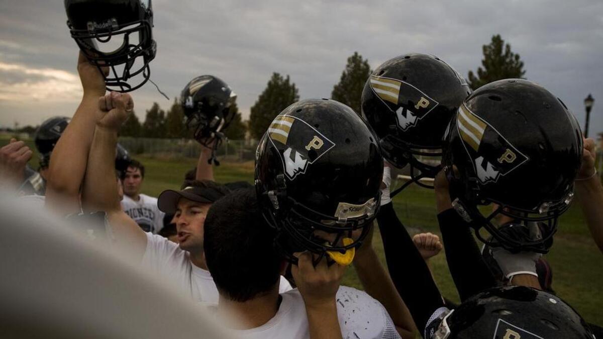 
Pioneer High School head football coach David Butterworth runs players through a drill during practice in Woodland in 2009. 
