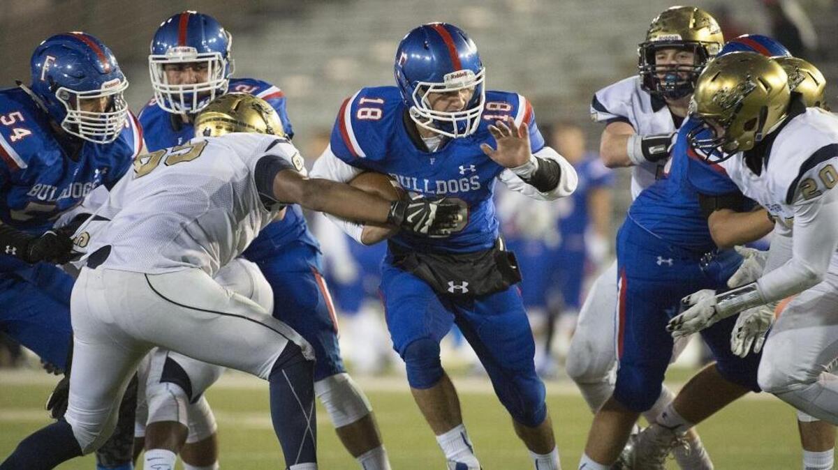 Bulldogs Jake Jeffrey (18) carries the ball during the Sac-Joaquin Section Division I championship game between the Folsom Bulldogs and the Elk Grove Thundering Herd at Sac State in Sacramento on Saturday, December 5, 2015.