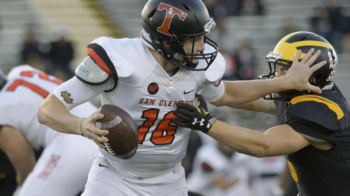 San Clemente quarterback Jack Sears is chased out of the pocket by Del Oro’s Trevor Johnson, right, during the CIF State Division I-A championship game at Sacramento State on Saturday, Dec. 17, 2016, in Sacramento, Calif.