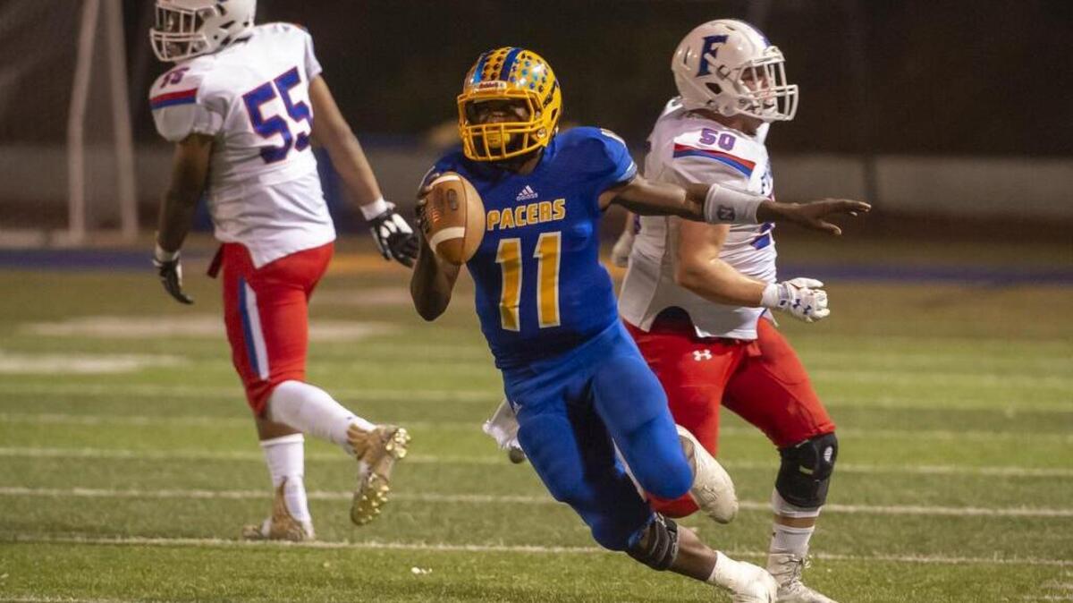 Grant’s Xavier Johnson (11) runs with the ball.