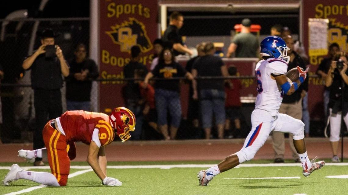 Folsom’s Isaiah Barner sprints past Oakdale’s Jace Krick on Friday at The Corral.