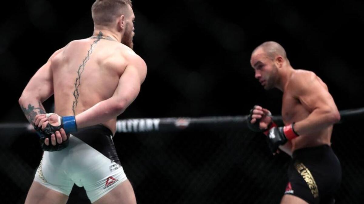 Conor McGregor, left, taunts Eddie Alvarez during a lightweight title mixed martial arts bout at UFC 205, early Sunday, Nov. 13, 2016, at Madison Square Garden in New York. McGregor won the bout.