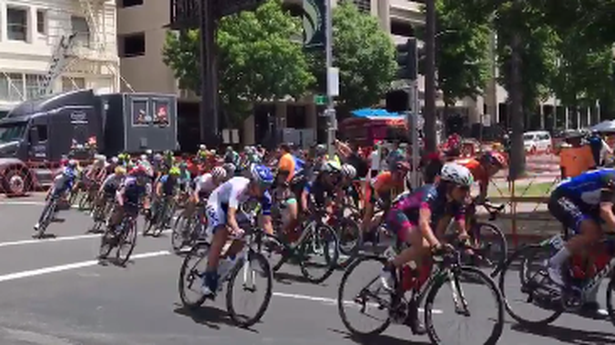 Cyclists in the women’s Amgent Tour of California race Stage 4 come around a corner in Sacramento on Sunday.