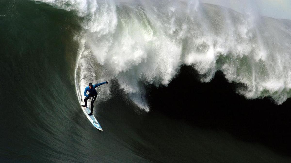 Grant Washburn rides down the face of a wave during the Mavericks Surfing Competition at Half Moon Bay on Tuesday, February 7, 2006. Washburn has riden Mavericks more often than anyone else on the contest list and is expected to compete in the 2016 Titans of Mavericks.