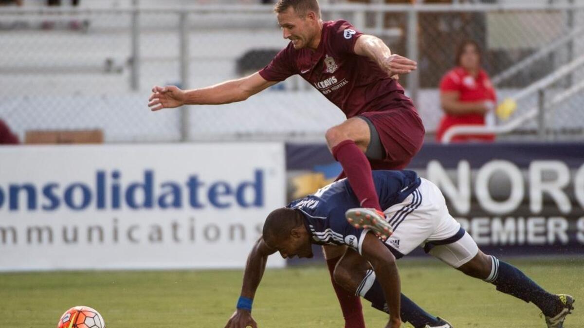 Republic FC forward Adam Jahn climbs over Real Monarchs SLC player Phanuel Kavita as he tries to get to the ball in the box in the first half of a USL match at Bonney Field in Sacramento, Calif., on July 6, 2016. Jahn, a Jesuit High School graduate who played with Republic FC on loan from the San Jose Earthquakes of the MLS, was traded to Columbus Crew SC on Saturday, July 30, 2016.