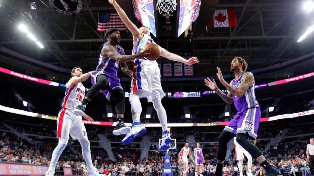 Sacramento Kings guard Ty Lawson (10), defended by Detroit Pistons center Aron Baynes, passes the ball to center Willie Cauley-Stein, right, during an NBA basketball game, Monday, Jan. 23, 2017, in Auburn Hills, Mich. Lawson and Cauley-Stein combined for 31 points.