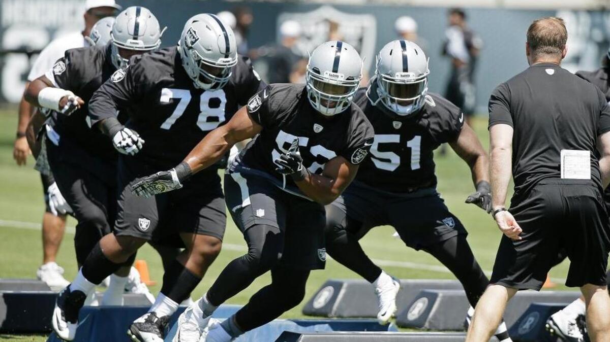 From left, Oakland Raiders defensive tackle Justin Ellis (78), defensive end Khalil Mack, and offensive linebacker Bruce Irvin take part in a drill during their football minicamp Tuesday, June 14, 2016, in Alameda, Calif. The Raiders open training camp Friday, July 29, in Alameda.