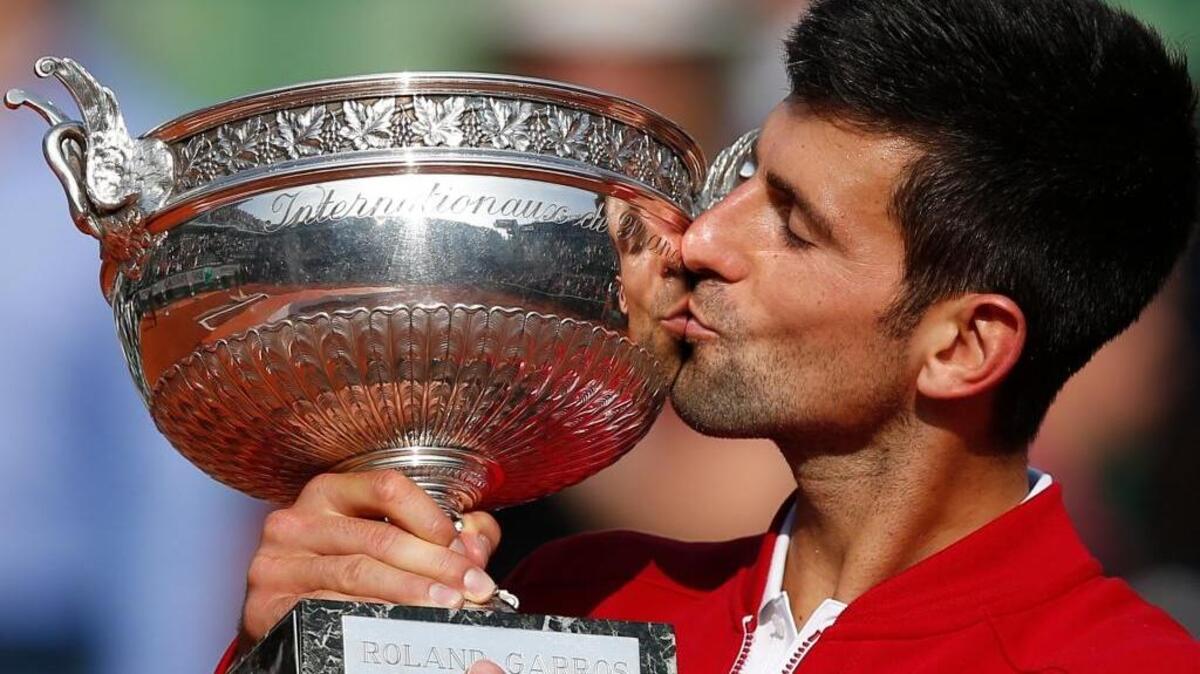 Novak Djokovic kisses the trophy after winning the final of the French Open tennis tournament against Andy Murray in four sets – 3-6, 6-1, 6-2, 6-4 – at Roland Garros in Paris on Sunday, June 5, 2016.