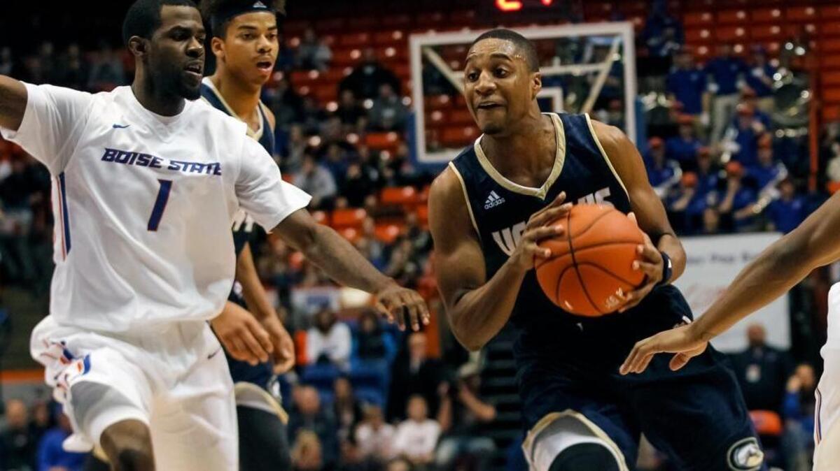UC Davis’ Brynton Lemar, right, moves the ball past Boise State’s Mikey Thompson during the first half on Dec. 30, 2015, in Boise, Idaho,