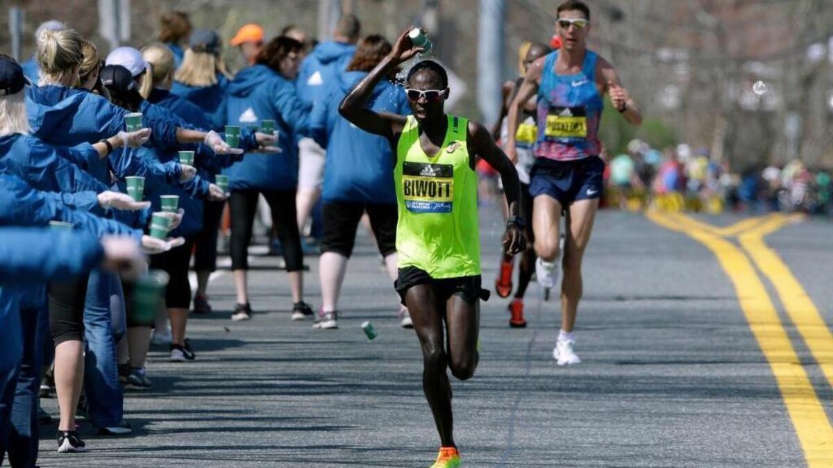 Shadrack Biwott of Folsom douses himself while running along the course of the 121st Boston Marathon on Monday in Natick, Mass. He finished fourth with a time of 2 hours, 12 minutes and 8 seconds.