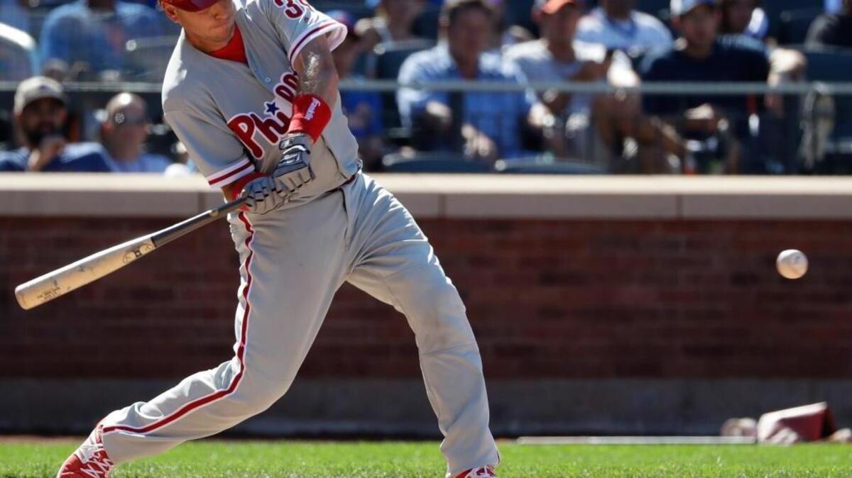 Philadelphia Phillies’ A.J. Ellis hits a two-run double during the seventh inning of a baseball game against the New York Mets, Sunday, Aug. 28, 2016, in New York. His trade from the Dodgers did not sit well with ace Clayton Kershaw. Ellis had been his catcher since they were minor league teammates in 2007.
