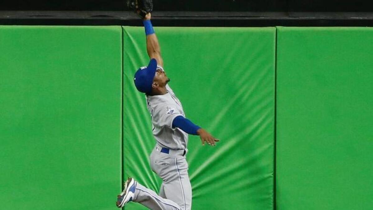Jarrod Dyson of the Kansas City Royals robs Christian Yelich of the Miami Marlins of a home run on Thursday, Aug. 25, 2016, in Miami.