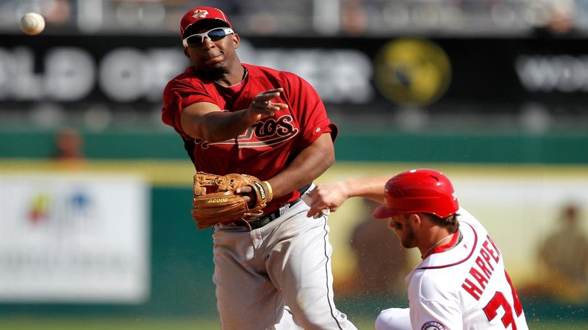 
Houston Astros second baseman Joe Thurston turns a double play as Washington Nationals’ Bryce Harper tries to break up the play during a spring training game March 4, 2012, in Viera, Fla. 
