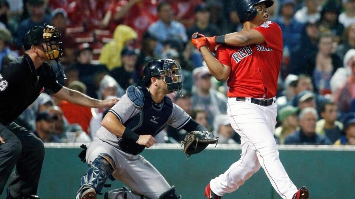 Boston Red Sox’s Rafael Devers hit a two-run homer against the New York Yankees on Aug. 18 in Boston. Did he receive a signal on what pitch was coming? The team allegedly stole signs with the help of Apple Watches during the series.