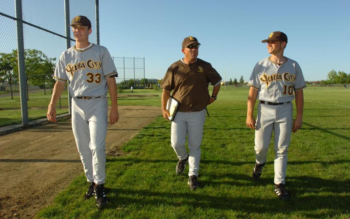 Yuba City High coach Jim Stassi, center, walks off the field at Natomas High School with his two sons Brock, left, and Max, right, in April 2007.
