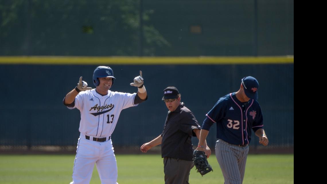 
UC Davis’ Nick Lynch (13) signals toward the Aggie bench after hitting a double in the first inning on Tuesday, March 31, 2015 in the college baseball game between the UC Davis Aggies and Saint Mary's Gaels in Davis.

