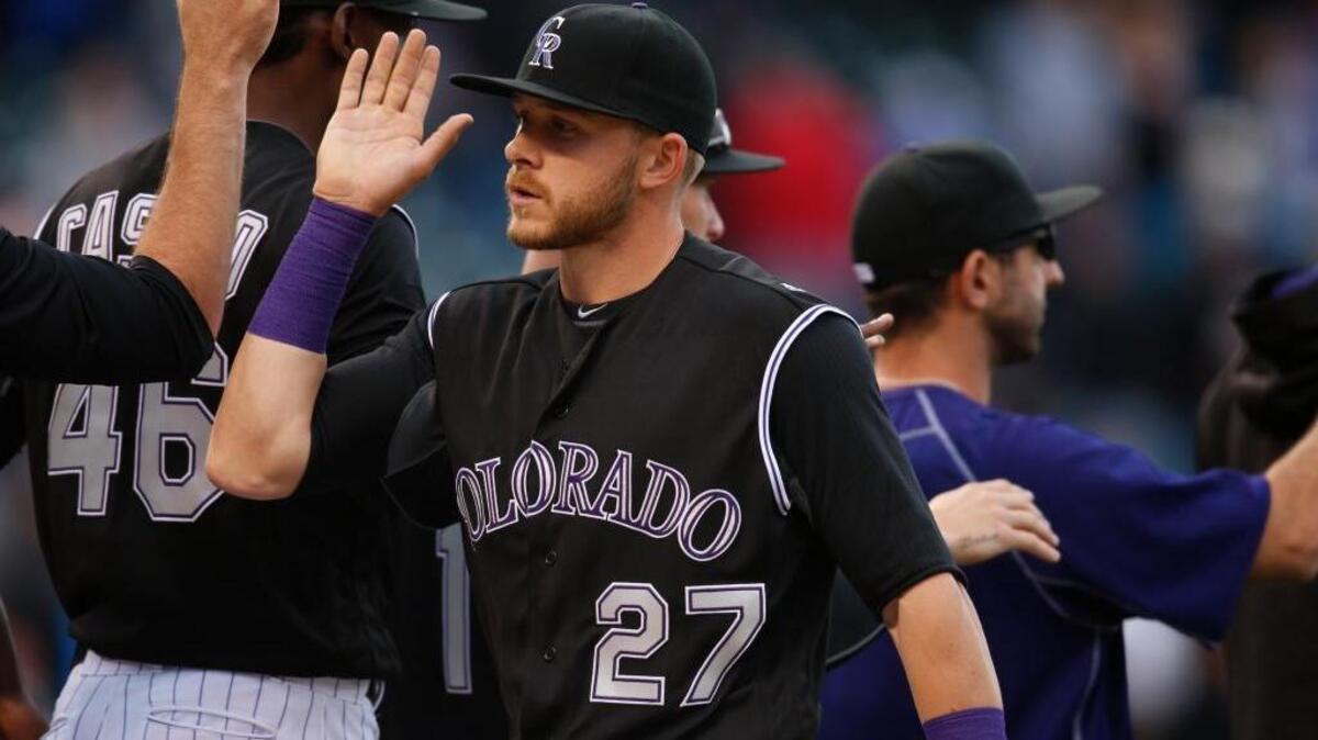 Colorado Rockies shortstop Trevor Story, front, is congratulated by teammates after a win over the San Diego Padres in a baseball game Sunday, April 10, 2016, in Denver. The rookie shortstop has hit seven home runs in his first six games.