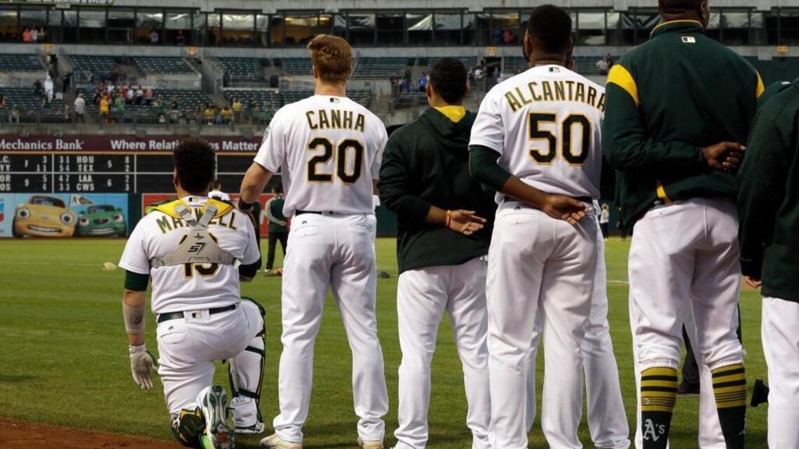 A’s rookie Bruce Maxwell kneels for the anthem. Oakland fans stand up for him.