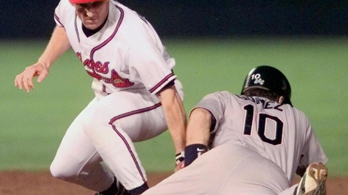 Atlanta Braves second baseman Keith Lockhart reaches to tag San Diego Padres Chris Gomez on a double in the fourth inning of the second game of the National League Championship Series at Turner Field in Atlanta, Thursday, Oct. 8, 1998. Lockhart’s son Jason was placed on life support on Friday after being hit in the face with a baseball.