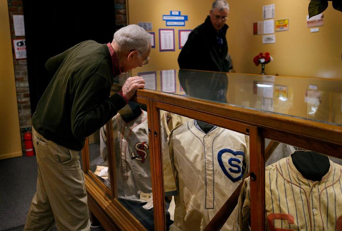 Cuno Barragan of Sacramento, left, former Sacramento Solons catcher from 1957-1960 and Chicago Cubs catcher from 1961-1963, and Tom Crisp of Davis examine historic baseball jerseys at the “History of Baseball in Sacramento” exhibit at the Folsom Historical Museum in 2017. The exhibit featured memorabilia from baseball teams in Sacramento, including jerseys, jackets and cards collected by Alan O’Connor.