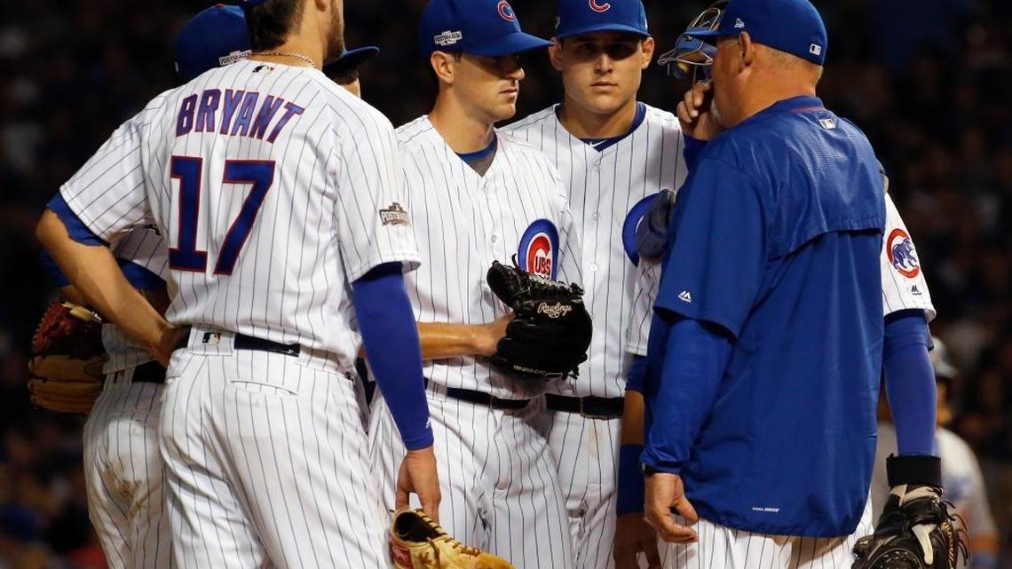 Chicago Cubs pitching coach Chris Bosio, right, talks to starting pitcher Kyle Hendricks during the third inning of Game 2 of the National League baseball championship series against the Los Angeles Dodgers, Sunday, Oct. 16, 2016, in Chicago.