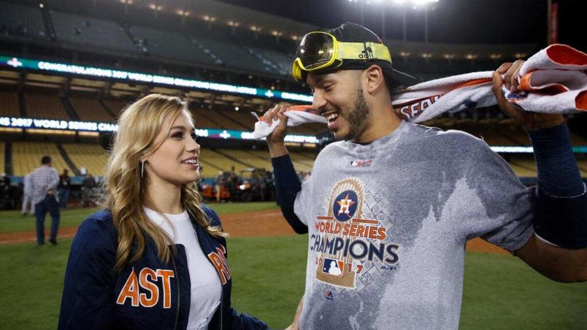 Houston Astros shortstop Carlos Correa speaks to his girlfriend, Daniella Rodriguez, after the Astros beat the Los Angeles Dodgers on Wednesday in Game 7 of the World Series. Correa proposed to Rodriguez at Dodger Stadium after the game.