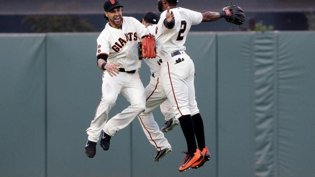 From left, San Francisco Giants outfielders Angel Pagan, Gregor Blanco, and Denard Span celebrate after a 1-0 win over the Chicago Cubs during a baseball game, Sunday, May 22, 2016, in San Francisco. The Giants took two of three games from the Cubs, who have the majors’ best record.