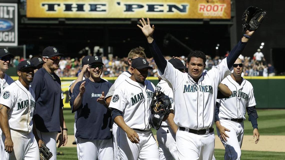 9. Felix Hernandez (143) – Seattle Mariners pitcher Felix Hernandez, front right, celebrates with teammates after tossing a perfect game in a 1-0 win over the Tampa Bay Rays on Wednesday, Aug. 15, 2012, in Seattle. King Felix, 29, is 143-101 with 2,142 strikeouts and a 3.11 ERA in 11 seasons.