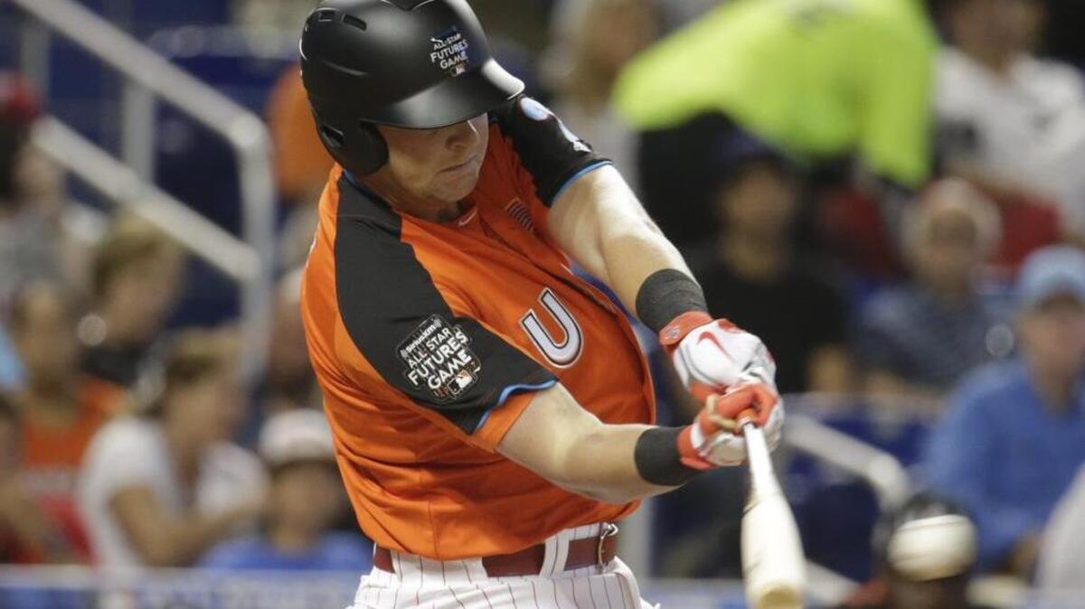 U.S. Team's Rhys Hoskins, of the Philadelphia Phillies, hits a single during the first inning of the All-Star Futures baseball game, Sunday, July 9, 2017, in Miami.