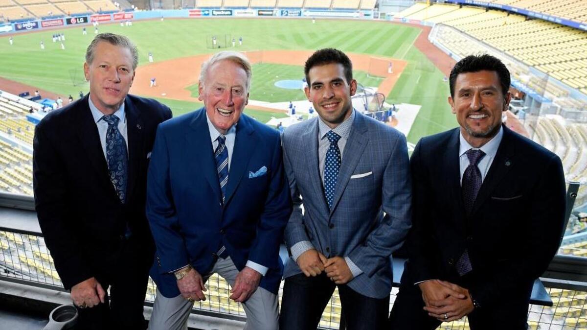 In this Tuesday, Sept. 20, 2016 photo, Dodgers broadcasters, from left, Orel Hershiser, Vin Scully, Joe Davis and Nomar Garciaparra pose before a baseball game between the Los Angeles Dodgers and the San Francisco Giants in Los Angeles. Davis worked road games for the Dodgers last season. He will call his first game as the team’s lead play-by-play announcer Wednesday, March 1, 2017, a spring training game from Arizona between the Dodgers and Giants.