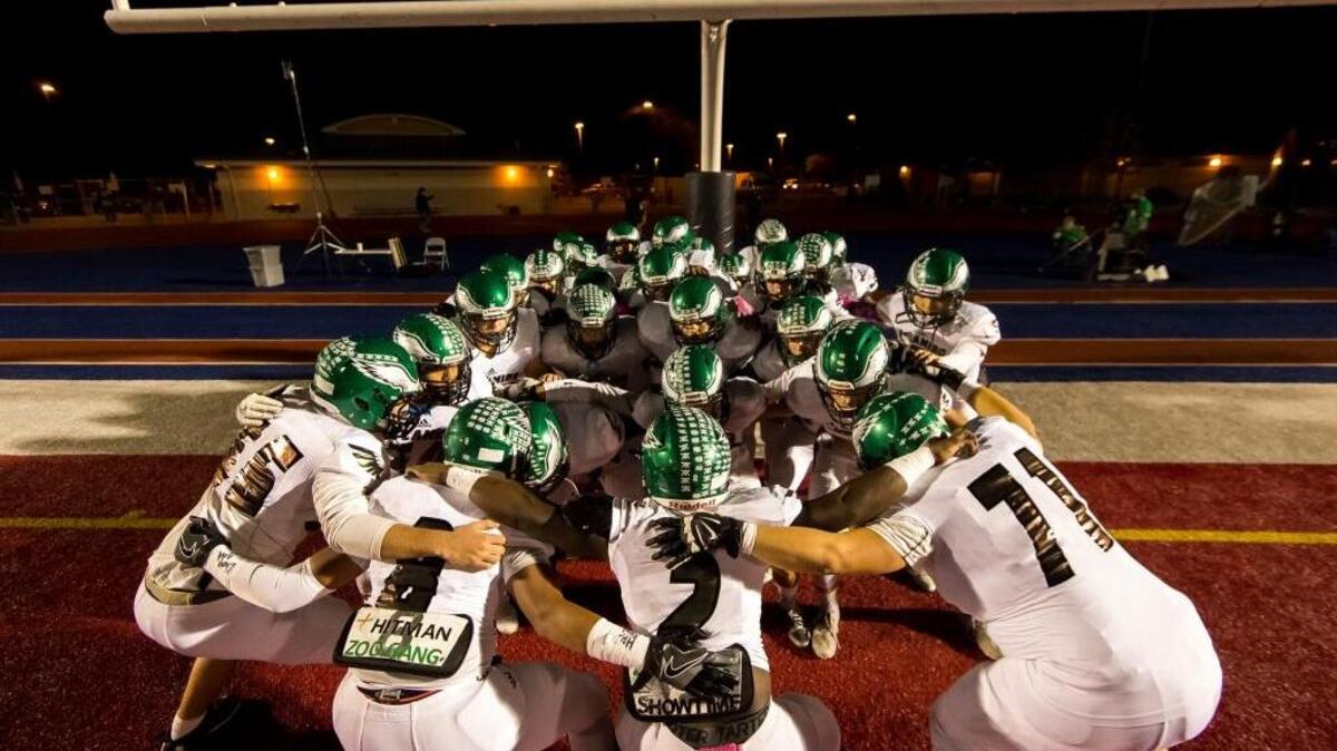 The El Camino High School football team huddles on the field before a game against host Vista del Lago on Friday, October 28, 2016, at Folsom High School.