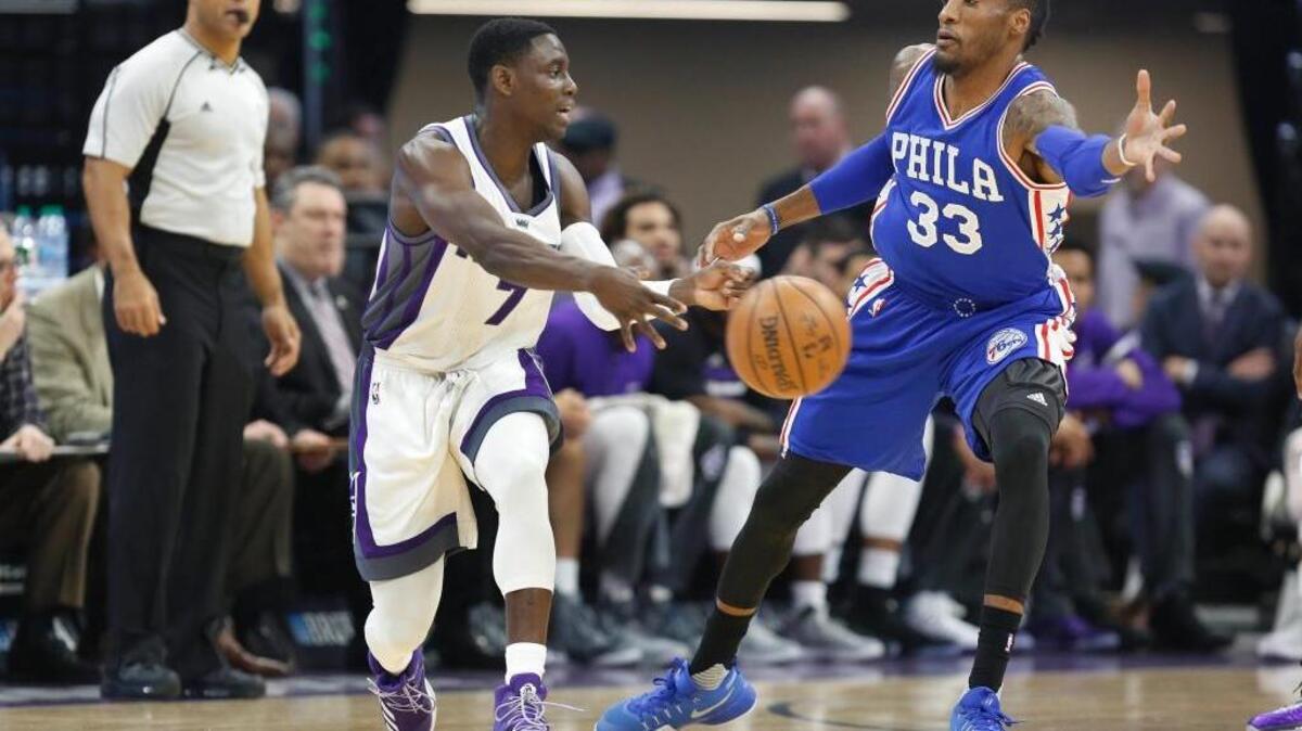 Sacramento Kings guard Darren Collison, left, passes around Philadelphia 76ers forward Robert Covington during an NBA basketball game at Golden 1 Center in Sacramento, Calif., on Monday, Dec. 26, 2016. The teams meet Monday, Jan. 30, 2017, in Philadelphia.