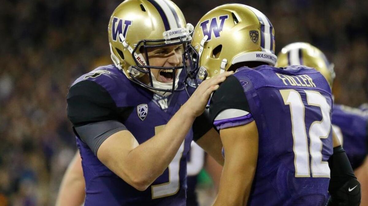Washington quarterback Jake Browning, left, is the nation’s highest-rated passer entering Week 7. Browning celebrates with wide receiver Aaron Fuller (12) after they connected for a touchdown Browning for a touchdown during the second half of an NCAA college football game against Stanford on Friday, Sept. 30, 2016, in Seattle.