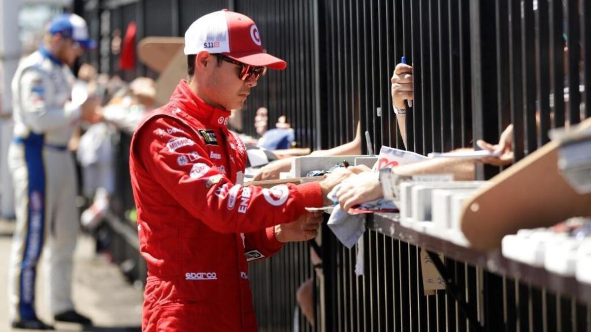 Kyle Larson signs autographs for fans before a race at Pocono Raceway on Sunday in Long Pond, Pa. The Elk Grove native has issued the Kids vs. Drivers cup-stacking challenge.