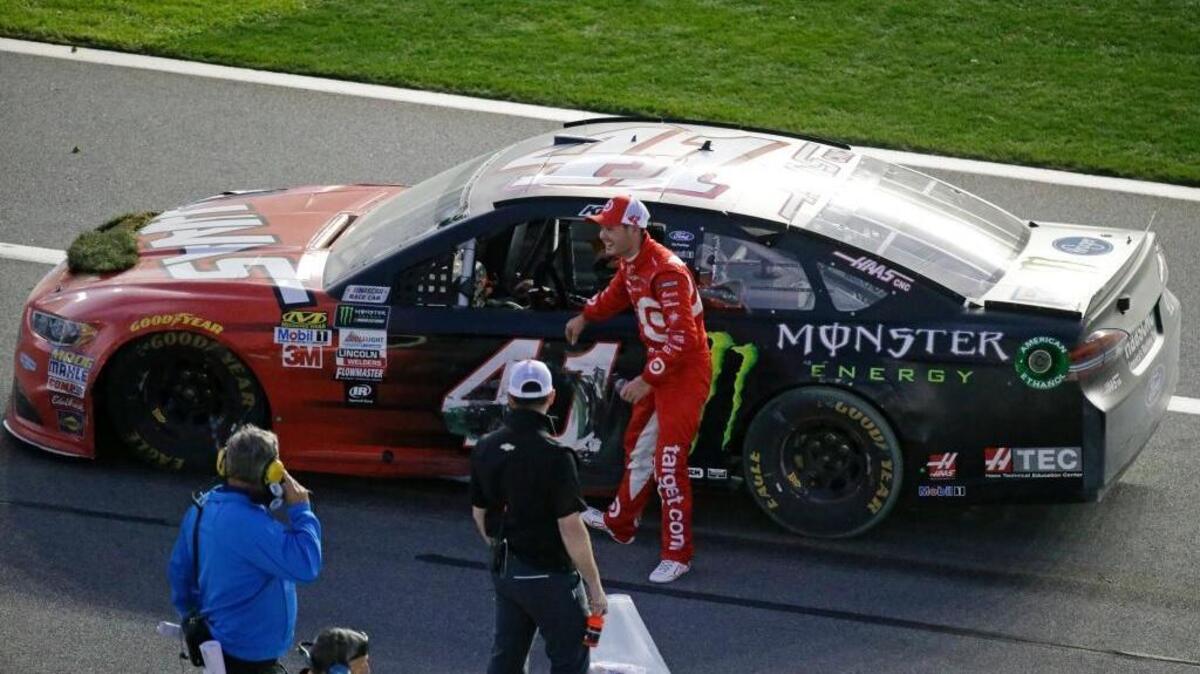 Kyle Larson, right, congratulates Daytona 500 winner Kurt Busch, in car, at Daytona International Speedway on Sunday, Feb. 26, 2017, in Daytona Beach, Fla.