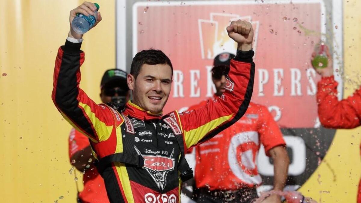 Kyle Larson raises his arms after exiting his car after winning a NASCAR Sprint Cup series auto race June 18, 2017, in Brooklyn, Mich. Larson returns to Michigan International Speedway for Sunday’s Pure Michigan 400.