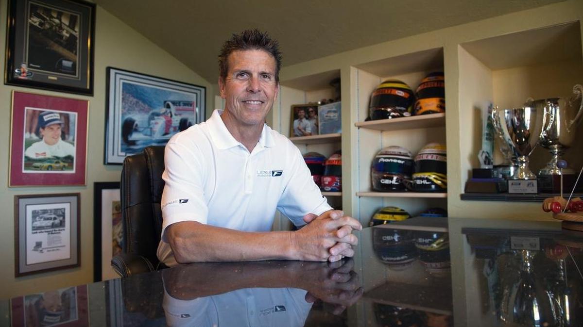 Hall of Fame race car driver Scott Pruett sits at his desk at his Auburn home on Tuesday.