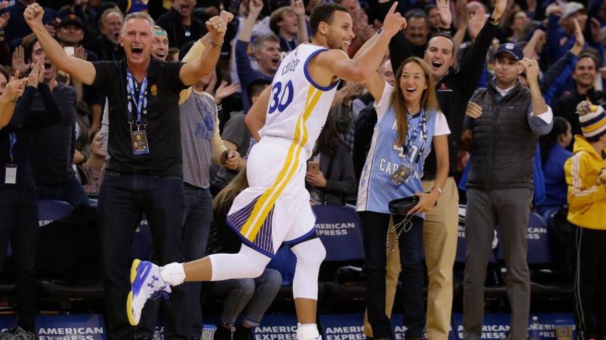 The Warriors’ Stephen Curry celebrates after a three-point basket against the Memphis Grizzlies during the second half of an NBA basketball game Monday, Nov. 2, 2015, in Oakland. Curry had a game-high 30 points and scored 21 of them in the third quarter.