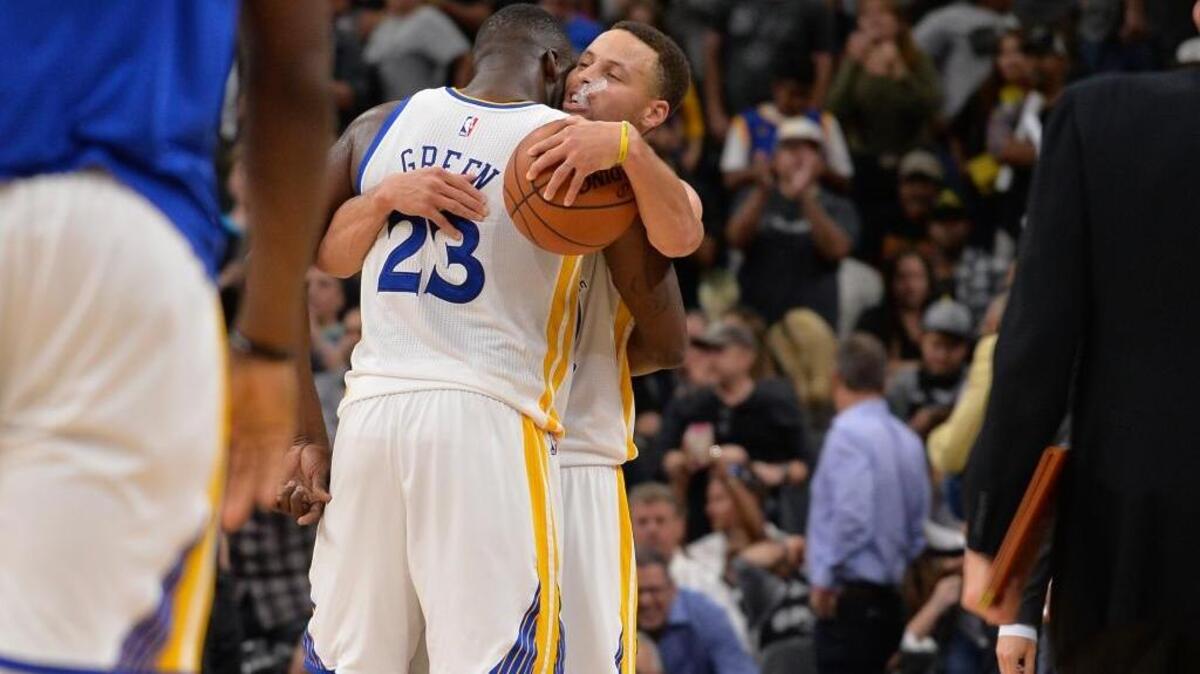 Golden State Warriors guard Stephen Curry, right, and Draymond Green embrace after beating the San Antonio Spurs in an NBA basketball game Sunday, April 10, 2016, in San Antonio. Golden State won 92-86 to tie the 1995-96 Chicago Bulls with 72 regular-season NBA wins.