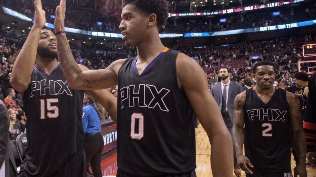 Phoenix Suns forward Marquese Chriss, center, high-fives teammate Alan Williams as they walk off court with Eric Bledsoe, right, following their victory over the Toronto Raptors in an NBA basketball game in Toronto on Sunday, Jan. 22, 2017. Chriss, a Sacramento native, will play in the Rising Stars game during NBA All-Star Weekend.