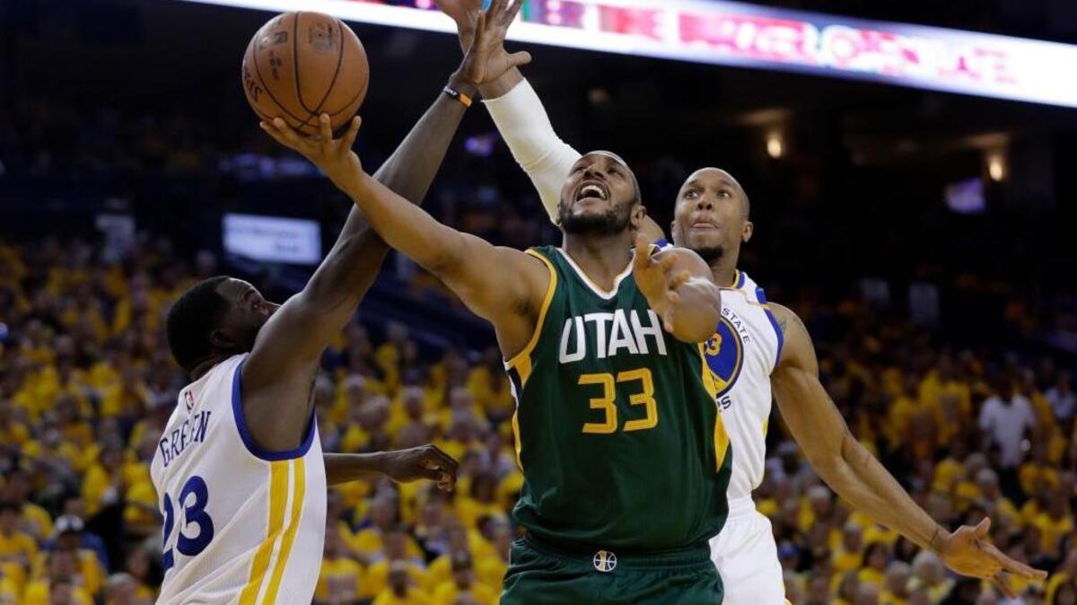 Golden State forwards David West, rear, and Draymond Green defend Utah’s Boris Diaw on Tuesday. The forwards are part of a second unit that is helping the Warriors close games with their defense and passing ability.