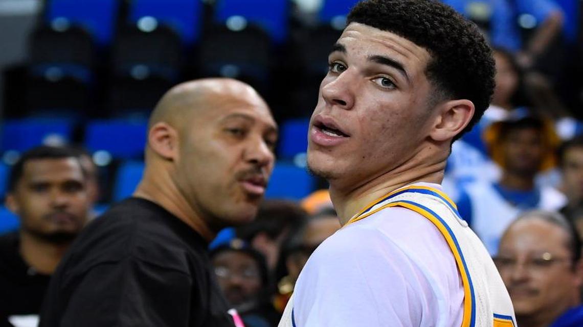UCLA guard Lonzo Ball, right, meets with his father, LaVar, after playing against Washington State on March 4. The elder Ball has started his own athletic apparel brand, but it’s the price of his shoes that is getting attention.