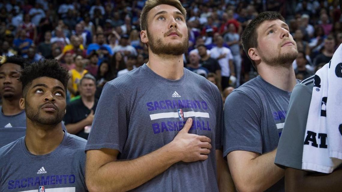 Eric Stuteville, center, the first Sacramento State player to make an NBA summer league roster stands for the national anthem with Kings teammates Frank Mason III, left, and Jack Cooley before a game in Las Vegas. Stuteville was the top pick in Saturday’s NBA G League draft.