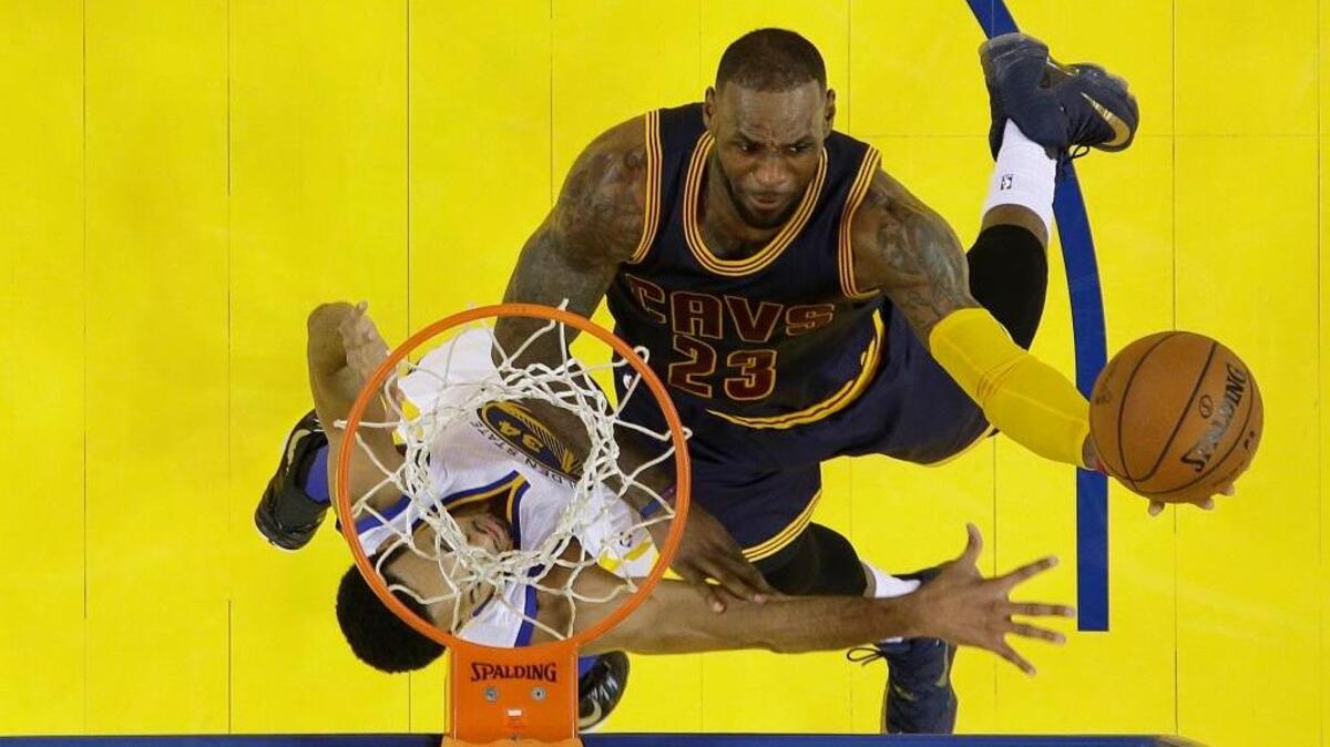Cleveland Cavaliers forward LeBron James (23) shoots against Golden State Warriors guard Shaun Livingston during the first half of Game 2 of basketball's NBA Finals , Sunday, June 5, 2016 in Oakland. James is averaging 21 points a game in the Finals.