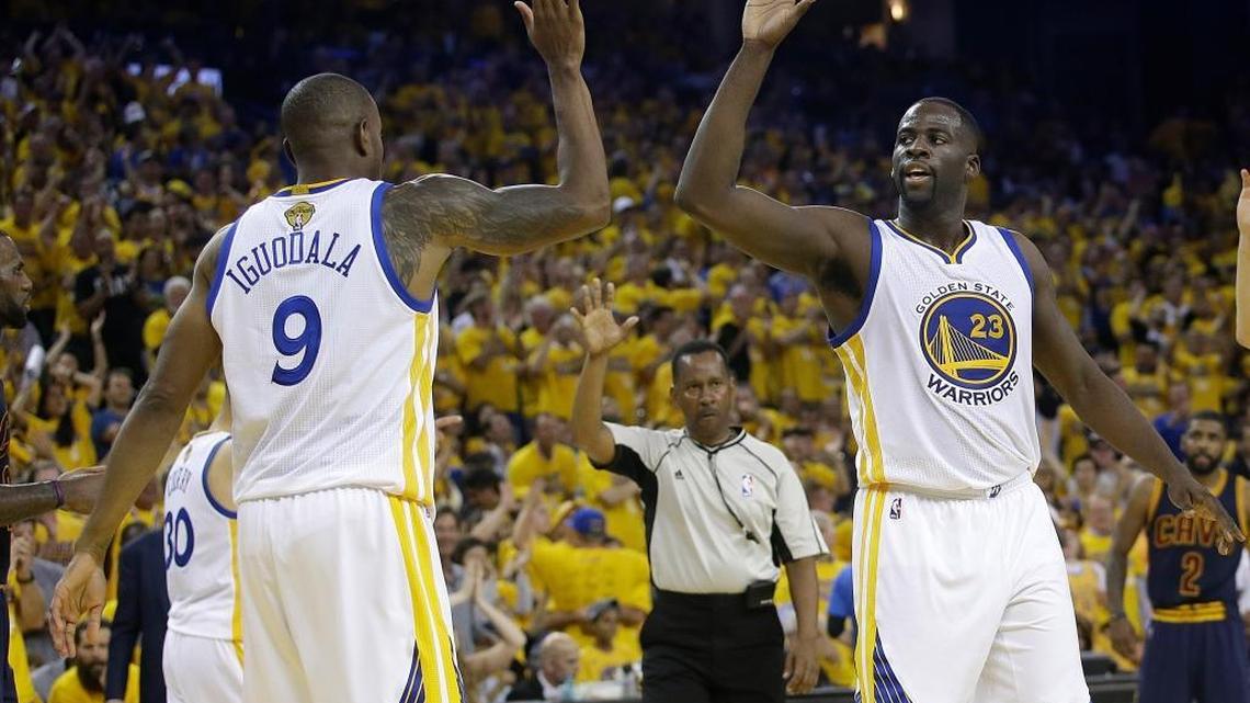 Golden State Warriors forward Draymond Green, right, and forward Andre Iguodala celebrate during Game 2 of basketball’s NBA Finals against the Cleveland Cavaliers in Oakland, Calif., on Sunday, June 5, 2016. Green scored 28 points to lead the Warriors to a 110-77 victory and a 2-0 series lead.