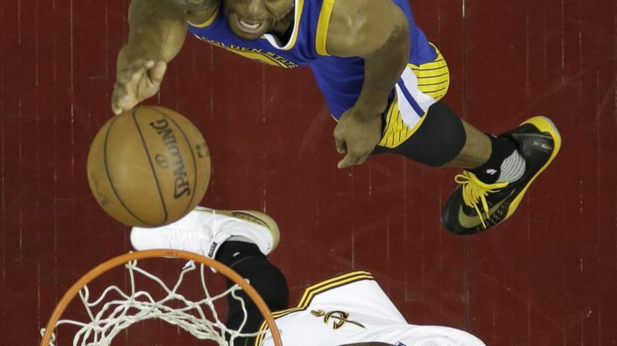 Golden State Warriors Andre Iguodala, top, drives to the basket against Cleveland Cavaliers' Kyrie Irving in the second half in Game 3 of the NBA basketball Finals, Wednesday, June 8, 2016, in Cleveland.